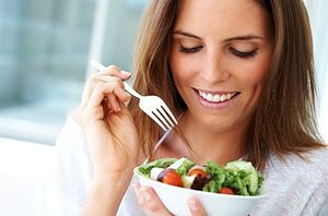 woman eating salad