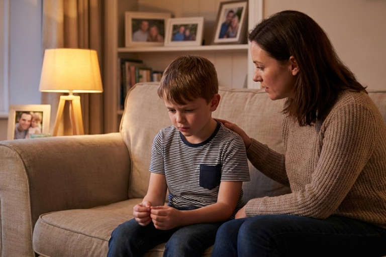 Parent sitting with their children and teenagers on the sofa, both looking thoughtful about getting help