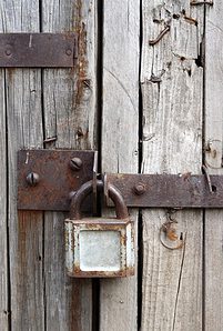 old rusty padlock on wooden door